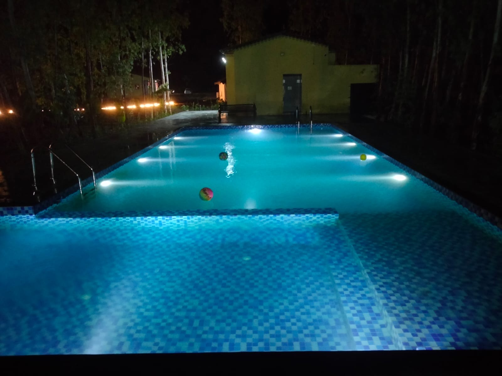 Resort swimming pool lit at night